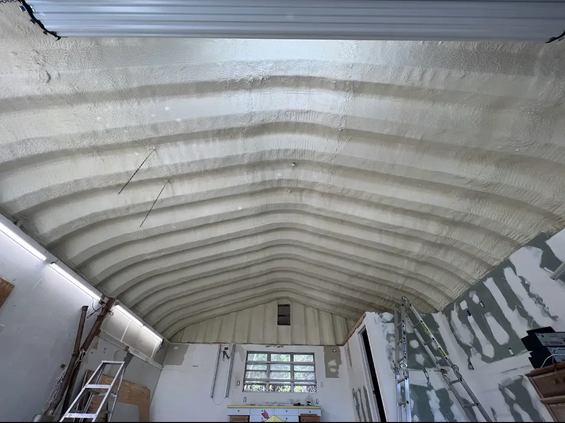 Spray polyurethane foam applied to the underside of a metal roof deck in Benson